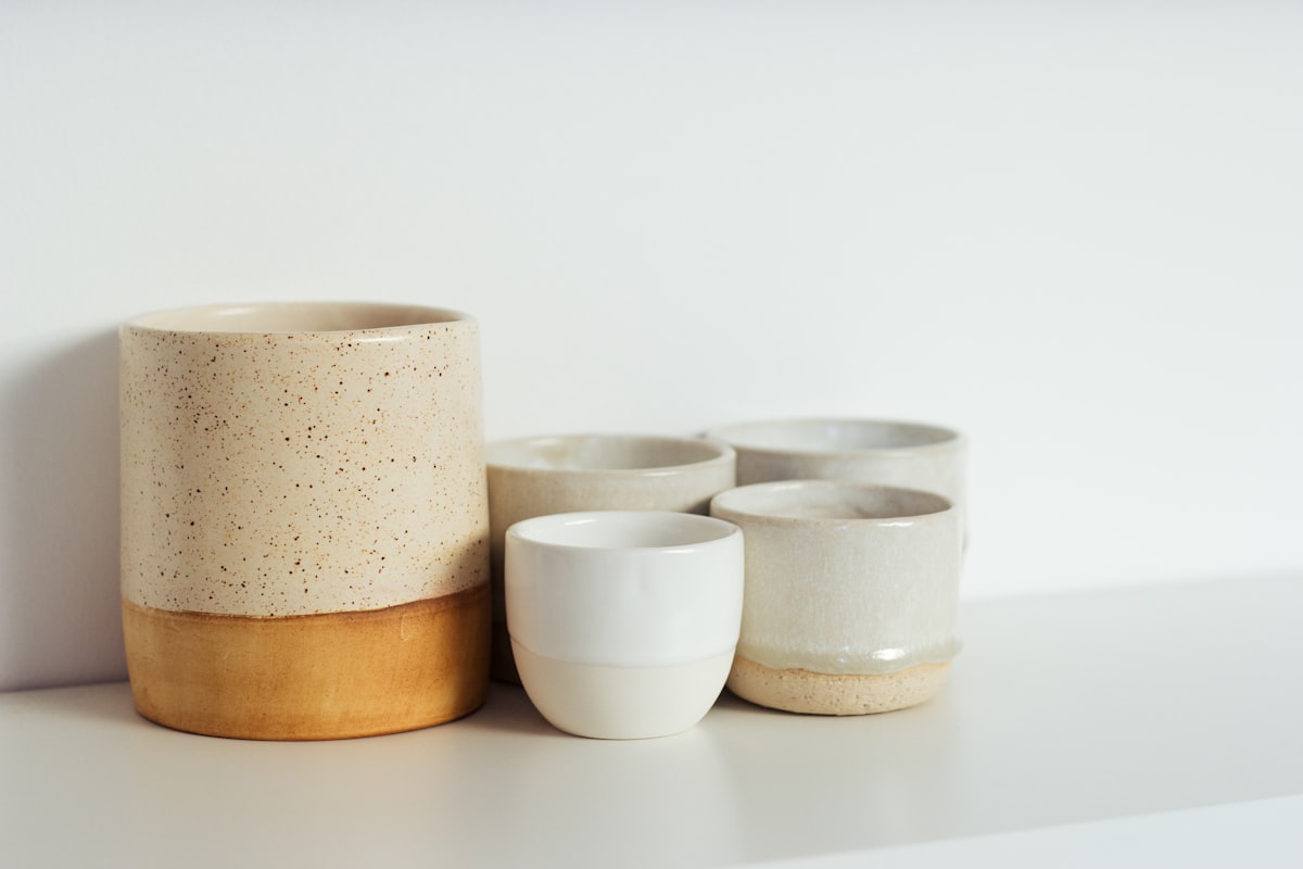 Handmade ceramic vessels with speckled glaze in warm tones